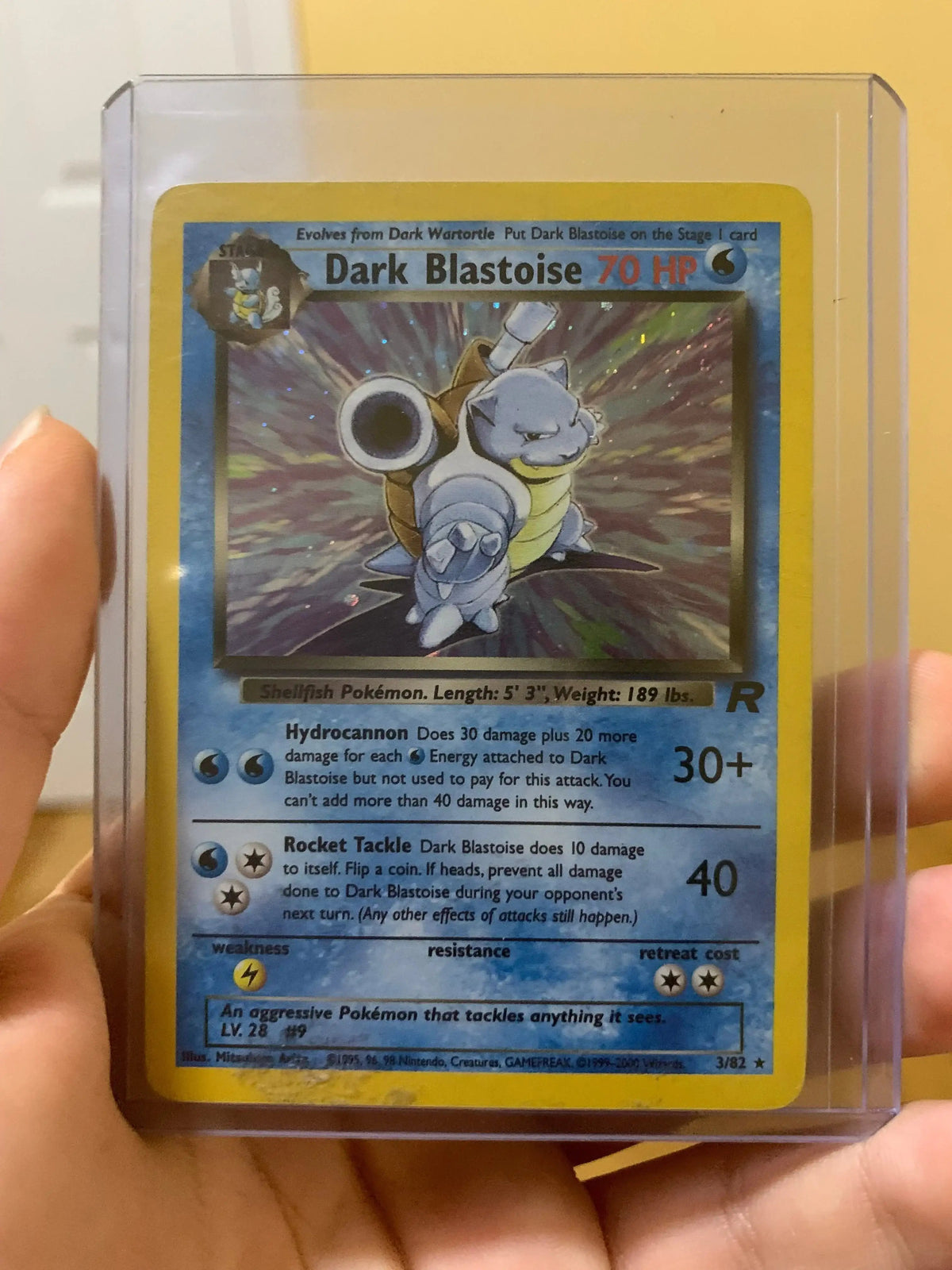 Dark Blastoise 70 HP holo Pokémon trading card in protective case, held by hand